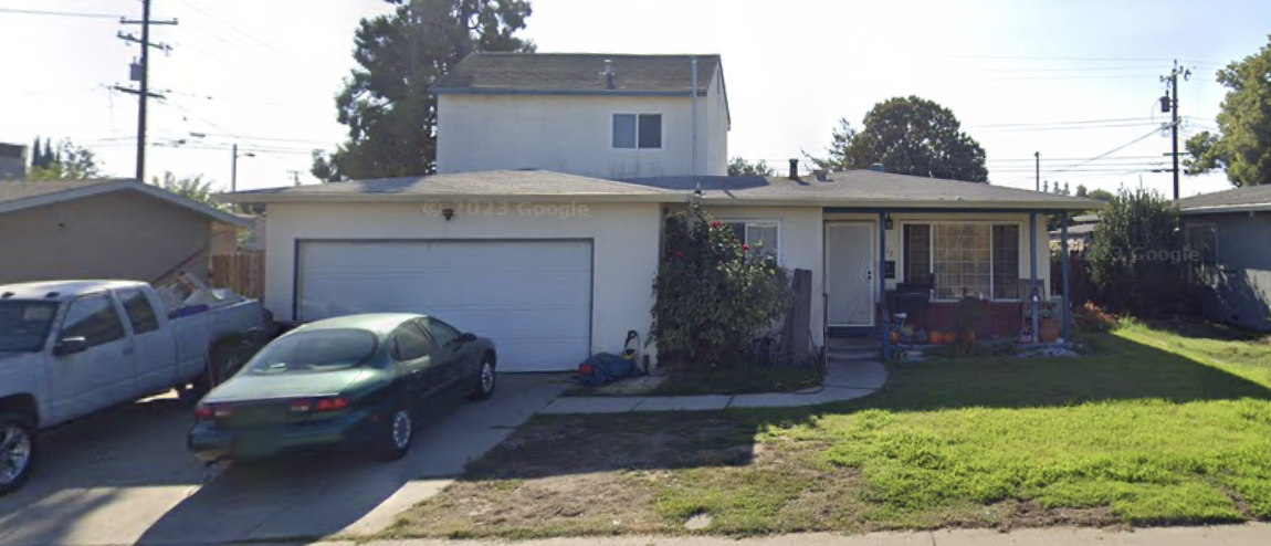 Suburban home with green lawn and driveway