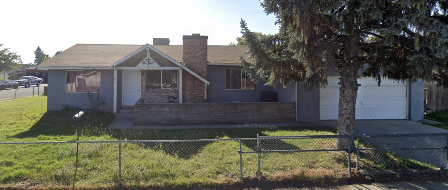 Corner lot home with brick chimney and front yard
