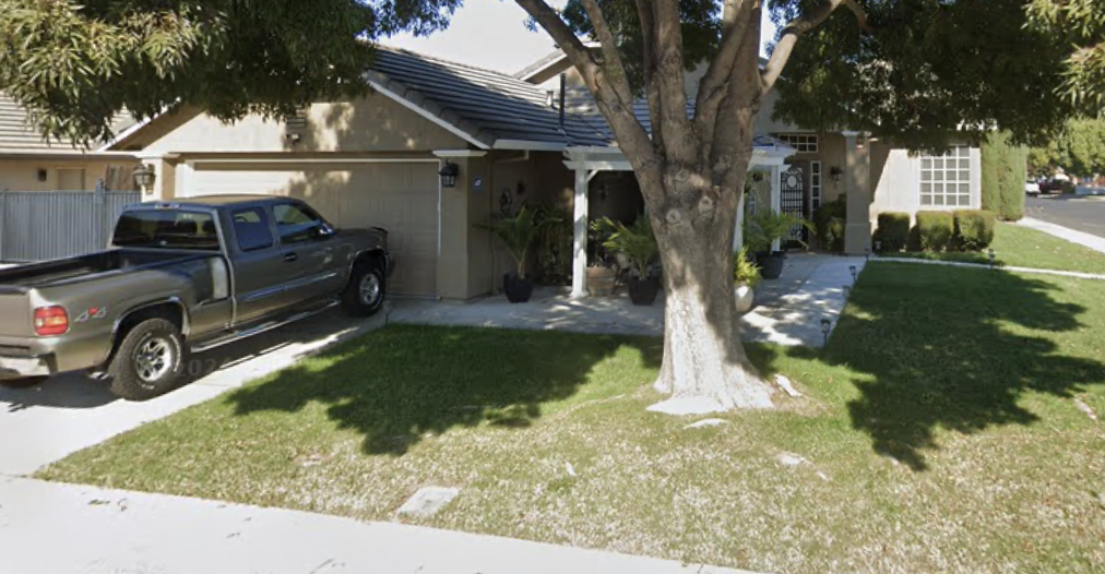 Single story suburban home and shaded front yard